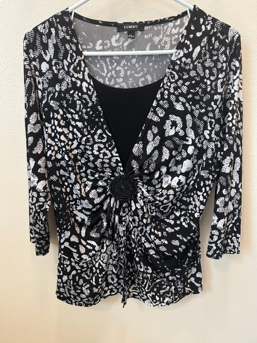 NWOT Elementz blouse in a black and white print, v-neck, & 3/4 sleeves, size L